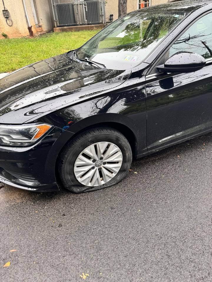Mobile Tire Repair 1 Flat front tire on a black car before mobile tire service